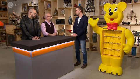 "Bares für Rares"-Experte Sven Deutschmanek und Moderator Horst Lichter bestaunen den Riesenbär von Stefan Möller