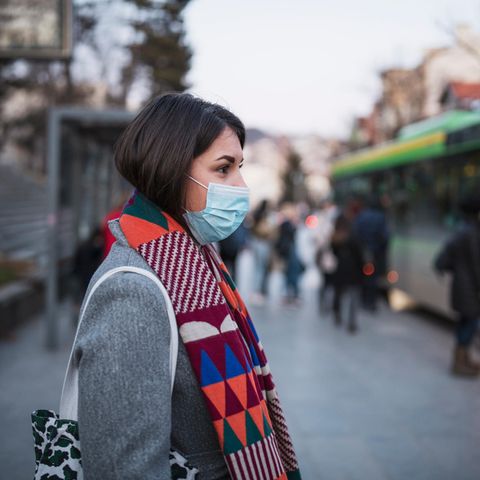 Coronavirus: Eine Frau mit Maske steigt in einen Bus
