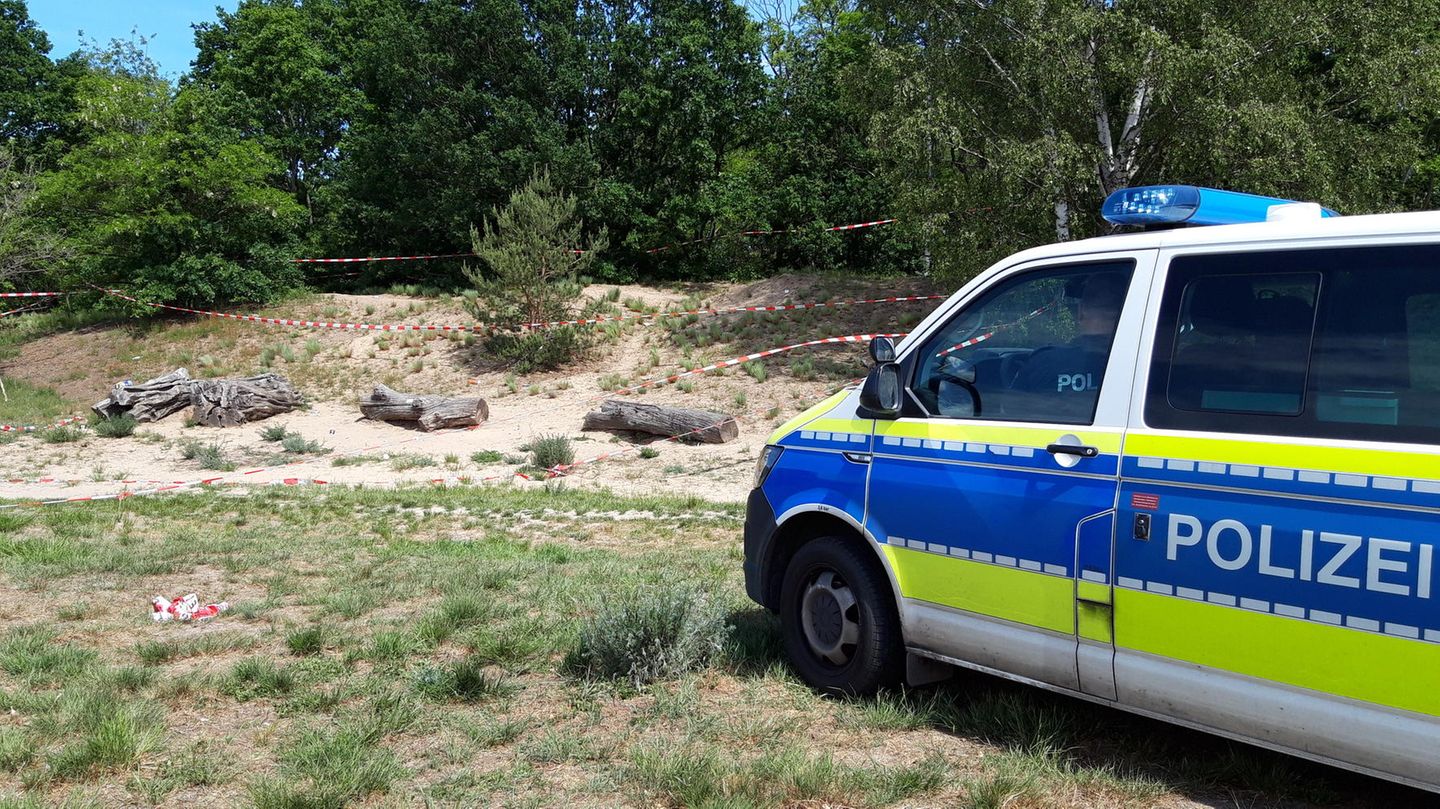 Ein Polizeiauto steht an der Stelle, an der ein Mann auf eine Menschengruppe geschossen und einen 27-Jährigen verletzt hat