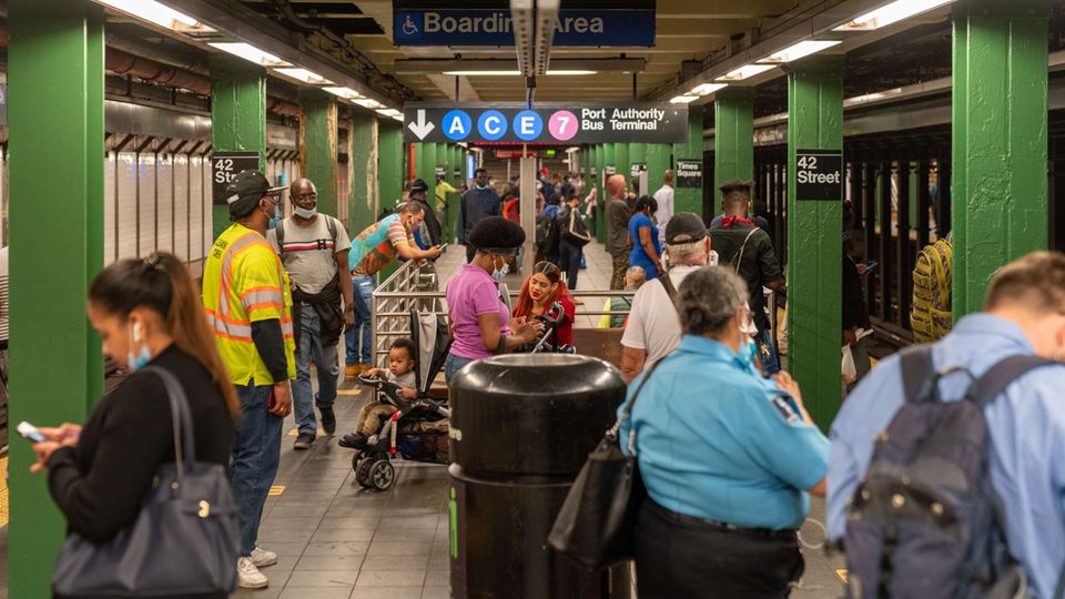 Passengers on the platform at the Times Square subway station