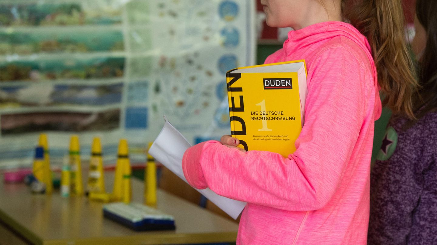 Ein Mädchen mit einem Duden unterm Arm