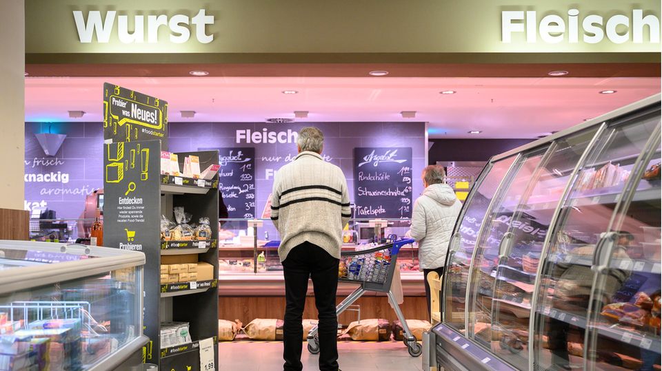 Baden-Württemberg, Stuttgart: Kunden stehen in einer Supermarkt-Filiale mit Abstand vor der Fleischtheke