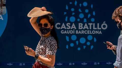 Spanien, Barcelona: Eine Frau mit Mundschutz und Sonnenbrille