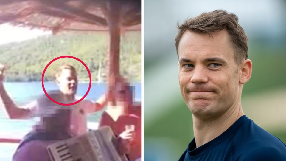 Bayern-Torwart Manuel Neuer steht in blauem Pullover da und kneift die Lippen zusammen