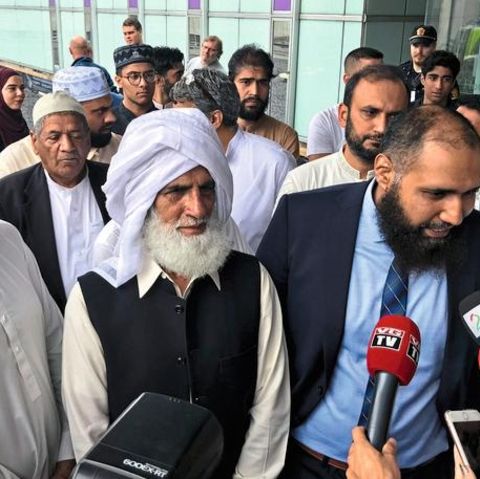 Mohammad Rafiq (C), one of the members of the congregation who stopped the attacker at a mosque, listens as people speak to media next to the Thon Oslofjord hotel in Sandvika, Norway August 11, 2019. REUTERS/Lefteris Karagiannopoulos - RC11DBFC5A40
