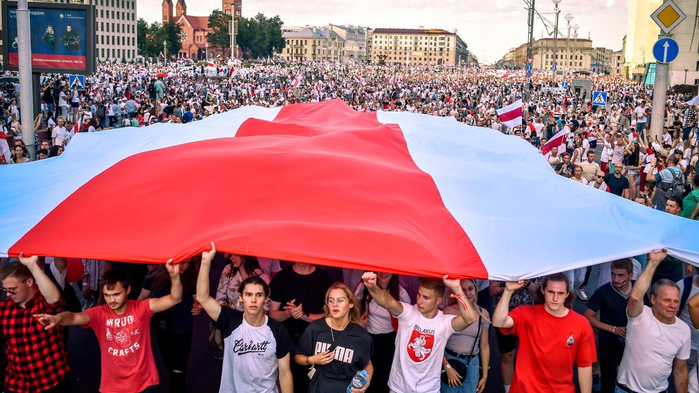 Demonstranten mit der ehemaligen weißrussischen Flagge