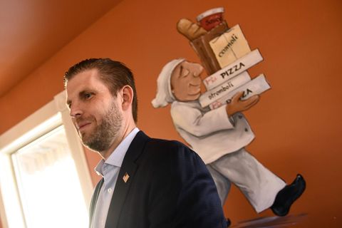 Eric Trump mit dem Bild eines Pizzabäckers an der Wand hinter ihm