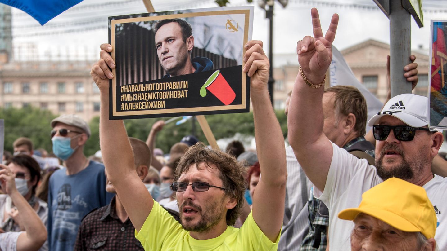 Ein Mann hält bei einer Demonstration im russischen Khabarovsk ein Plakat mit einem Porträt von Alexej Nawalny hoch