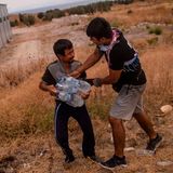 Zwei Migranten streiten sich um Wasserflaschen