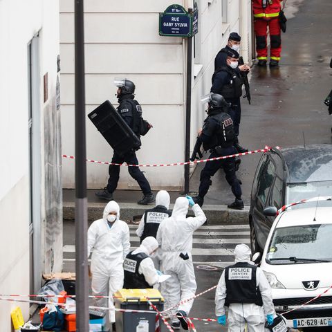 Frankreich, Paris: Polizisten stehen neben der Absperrung des Tatortes