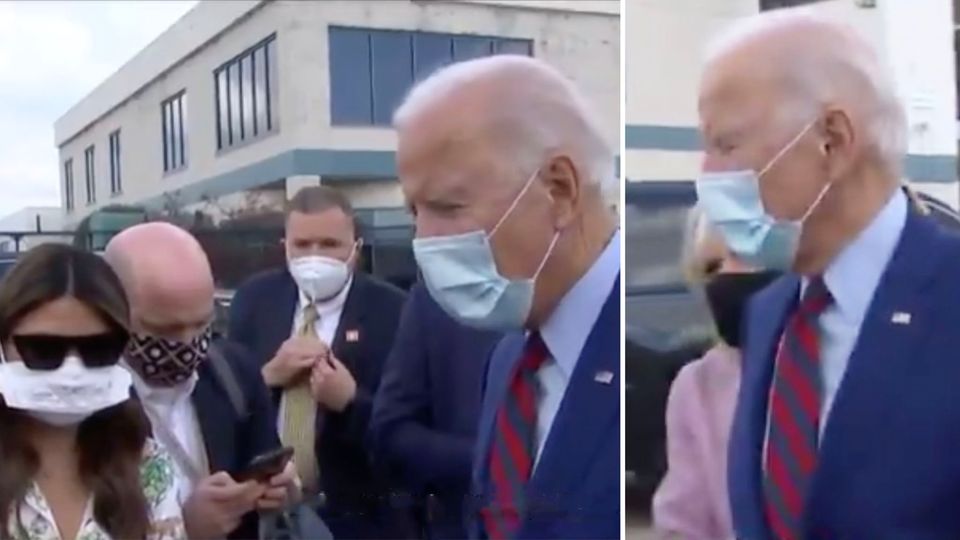 US-Präsidentschaftskandidat Joe Biden trägt einen dunkelblauen Anzug sowie eine Artemmaske und dreht seinen Kopf nach rechts
