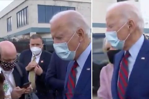 US-Präsidentschaftskandidat Joe Biden trägt einen dunkelblauen Anzug sowie eine Artemmaske und dreht seinen Kopf nach rechts