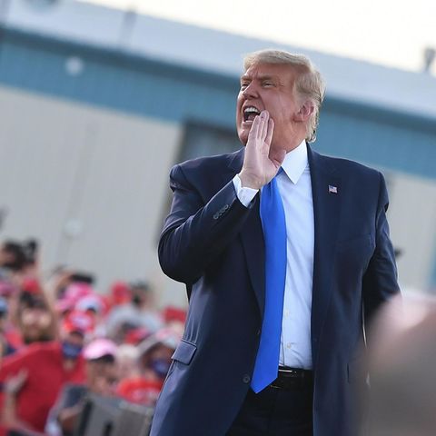 Donald Trump schreit zur Seite mit vorgehaltener Hand