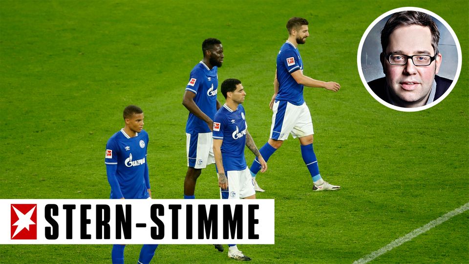 Vier Fußballspieler in blauen Schalke-Trikots gehen niedergeschlagen über den Platz
