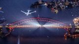 Geburtstagsfeier der Qantas zum hundertjährigen Bestehen Mitte November: Eine Boeing fliegt über die festlich illuminierte Harbour Bridge im Hafen von Sydney.