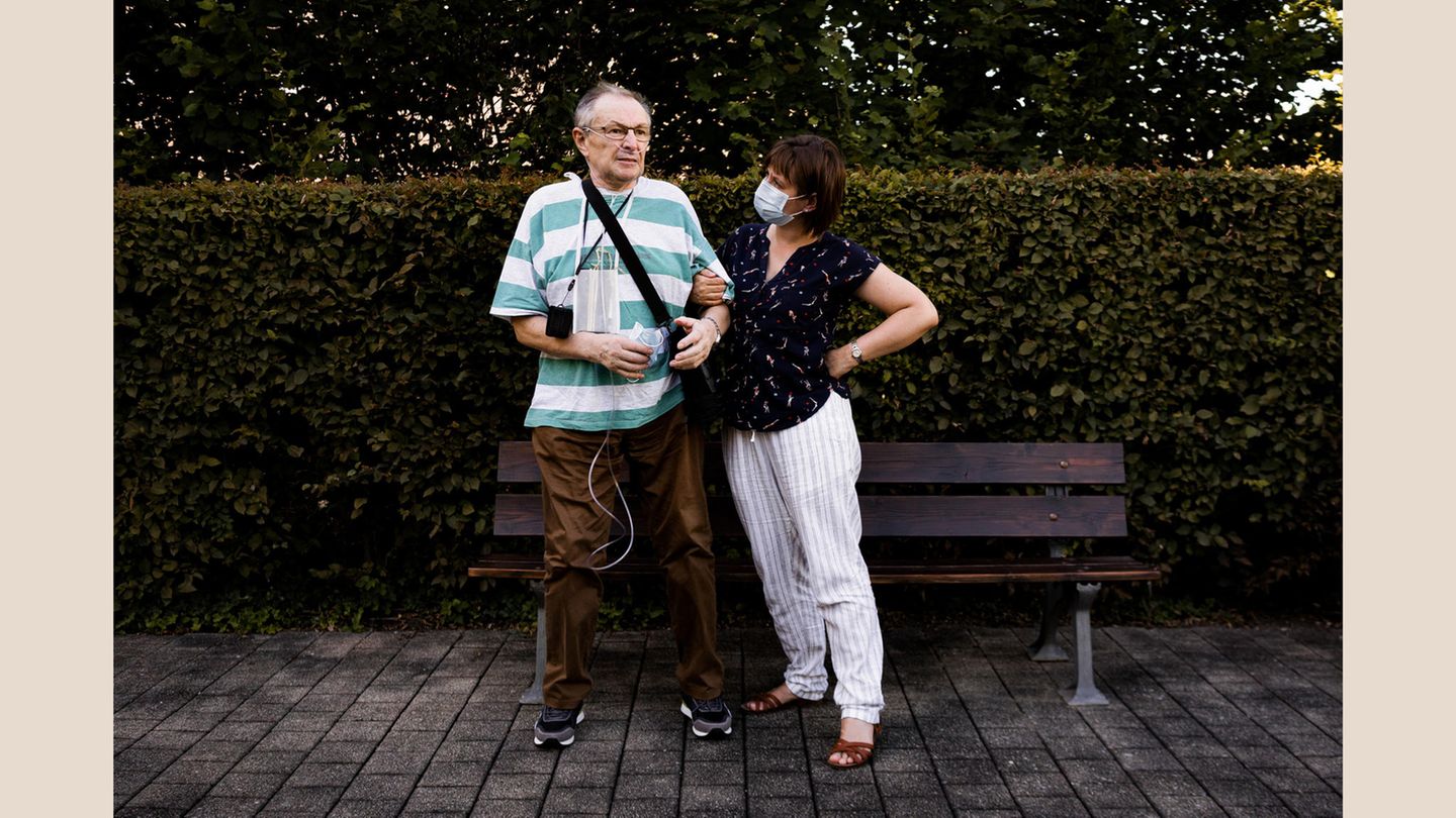 Wenzel D., 68, Covid-19-Patient  Fotojournalist Patrick Junker begleitete in der ersten Welle Covid-19-Patienten, Ärzte und Pflegepersonal und dokumentierte den Alltag in der Pandemie. Die Bilder sollen Solidarität wecken und den gesellschaftlichen Zusammenhalt in der Corona-Pandemie stärken.  Das Bild zeigt Wenzel D. (68), hier zusammen mit seiner Tochter Katerina. D. erkrankte schwer am Virus und lag wochenlang im Koma. Er überlebte, doch der Weg zur Genesung ist lang: "Meine Lunge tut nicht weh, aber sie ist sehr geschädigt. Meine Finger fühlen sich steif an und schmerzen, wenn ich etwas anfasse. Ich habe 16 Kilo Gewicht verloren, sehr viel Muskulatur, und immer noch halb so viel Kraft wie vor meiner Erkrankung. Jeder Schritt strengt an", sagt Wenzel D.  Nach dem Aufenthalt im Stuttgarter Marienhospital und der Lungenklinik wurde er in die "Klinik für Geriatrische Rehabilitation" des Klinikums Christophsbad in Göppingen verlegt. Die Reha half ihm dabei, langsam in den Alltag zurückzufinden.      Infos zum Projekt: Im Interview unter dieser Fotostrecke erfahren Sie mehr zu dem Hintergrund des Fotoprojekts. Am 17. Dezember um 19:30 Uhr wird Fotograf Patrick Junker zudem in einem Live-Interview mit Sara Dahme im KULTUR KIOSK Einblicke in seine Arbeit geben. Zur Liveübertragung geht es hier.  Ab sofort gibt es auch eine Versandaktion der Projektzeitung auf Spendenbasis. Bis zum 17. Dezember werden Bestellungen angenommen und Spenden für die "Künstler*innen Soforthilfe Stuttgart" gesammelt. Die Zeitungen können Sie hier bestellen.