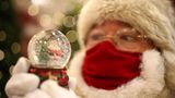 London: Ohne Mundschutz geht in diesem Jahr nichts  In einer Filiale des Kaufhauses Selfridges trägt dieser Weihnachtsmann einen Mund-Nasen-Schutz und hält eine Schneekugel in den Händen.