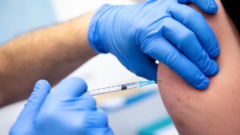 Ein Klinik-Mitarbeiter wird mit dem Corona-Impfstoff von Biontech/Pfizer geimpft